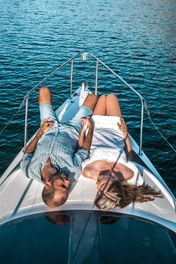 Young couple at the bow of a motoryachts