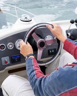 Captain in the cockpit of a motorboat