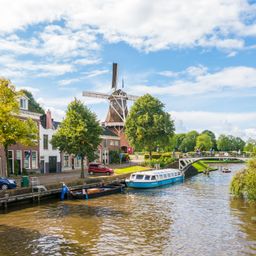 ZWindmolen en brug over kanaal in historische oude stad Dokkum, Friesland, Nederland