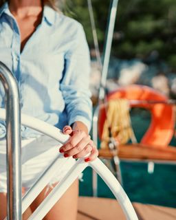 Person at the helm of a sailboat