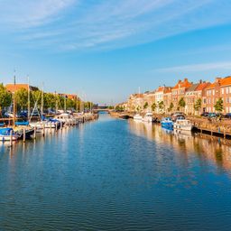 Zeilboot in de Zeeuwse wateren met typisch Nederlandse wolkenlucht